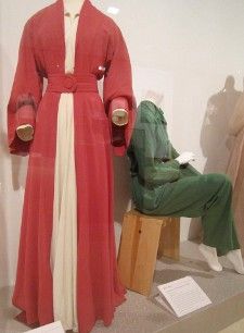 A Valentina red silk coat dress made for the original Broadway production of The Philadelphia Story and a green raw silk jumpsuit the private Hepburn wore