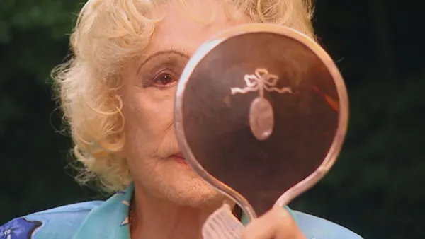 Leni Riefenstahl checks her appearance for the recording of the three-part documentary "Speer Und Er" by director Heinrich Breloer