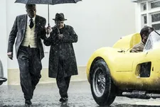 Adam Driver as Enzo Ferrari wearing the yellow sweater