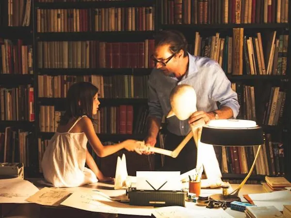 Fabrizio Gifuni as Luigi with Anna Mangiocavallo as his little daughter Francesca, discussing Pinocchio
