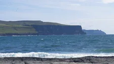The Cliffs of Moher, with the harsh Atlantic winds blowing from the sea.