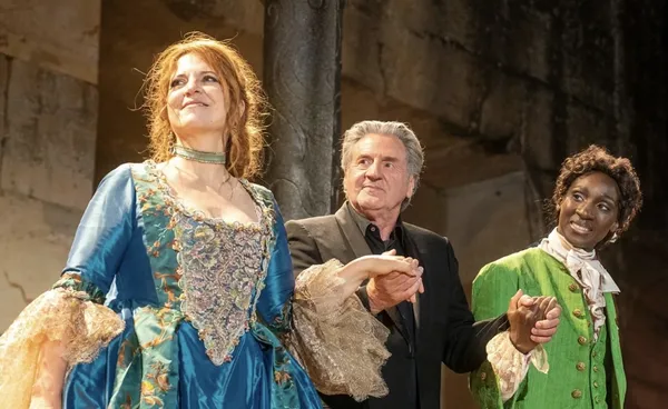 Three people take a curtain call