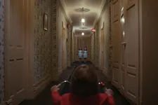 Danny taking aim at the twins, Lisa Burns and Louise Burns in The Shining