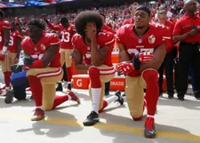 Colin Kaepernick (7) takes a knee and is joined by Eli Harold (58) and Eric Reid (35)