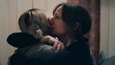Anja (Andrea Bræin Hovig) hugging her daughter Julie (Elli Rhiannon Müller Osbourne)