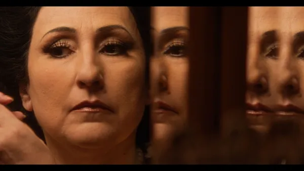 A woman's face repeated in reflection