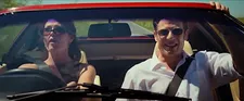 Anne Archer (Gemma Arterton) driving to the lighthouse and listening with Robert Freegard (James Norton) to Just Like Heaven by The Cure