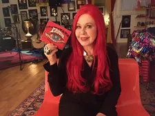 Kate Pierson holding up the Fanny Walked The Earth CD