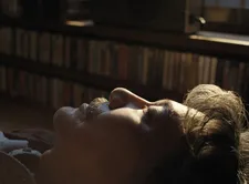 Hirayama (Kôji Yakusho) asleep with his books