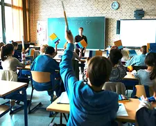 Ms Nowak (Leonie Benesch) in the classroom with her students holding up their books