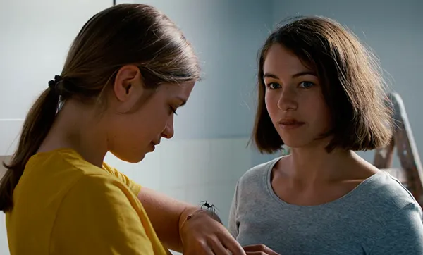 Lisa (Liliane Amuat) and Mara (Henriette Confurius) and the spider in Silvan Zürcher and Ramon Zürcher’s moving tapestry The Girl And The Spider