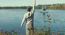 Jeff (Noah Parker) waving to Blake  (Arieh Worthalter) arriving on the seaplane