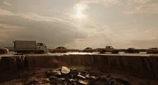 A flooded road looks as if it is in the middle of collapsing, with chunks breaking away, turning the path into a waterfall.