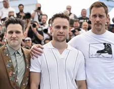 British director/writer Harry Lighton, flanked by actors Harry Melling, left, and Alexander Skarsgård awarded for best screenplay for Pillion
