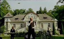 A musician (Rita Sasnal) and the maid (Aleksandra Nowosadko) play for Tobler (Andrzej Konopka)