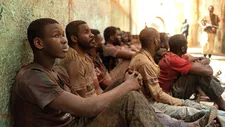 Seydou (Seydou Sarr) with Martin (Issaka Sawadogo) in prison