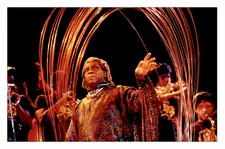 Sun Ra under copper arches with Arkestra on stage