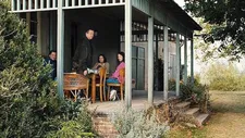 Max (Enno Trebs), Richard (Matthias Brandt), Betty (Barbara Auer), and Laura (Paula Beer) on the veranda