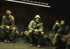 Jonathan (Yonaton Shiray) raises his hand with his fellow soldiers