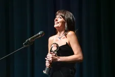 Dakota Johnson proudly clutches her President’s Award at the Karlovy Vary International Film Festival